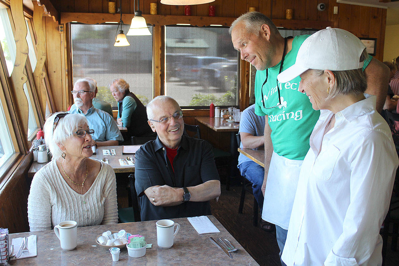 Freeland Cafe new owners Jeff and Deb Kennelly talk to customers during a busy Father’s Day Sunday breakfast. Photo by Patricia Guthrie/Whidbey News Group
