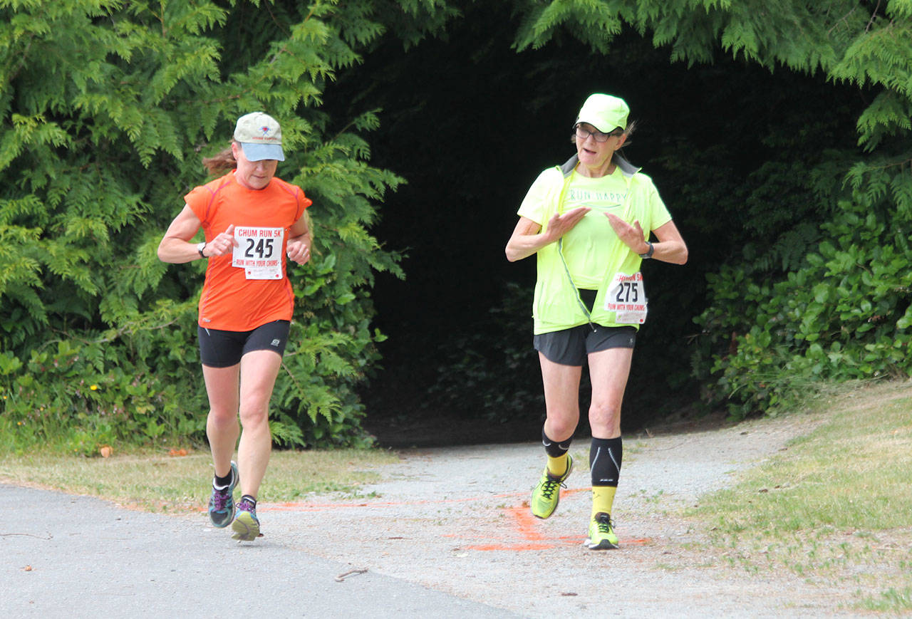 Trisha Hallgren, left, and Joani Wright run the course together.(Photo by Jim Waller/South Whidbey Record)