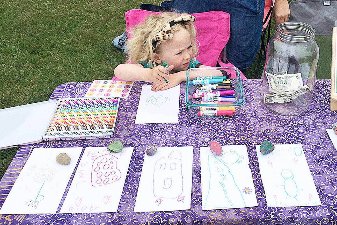 Young girl sells art for school