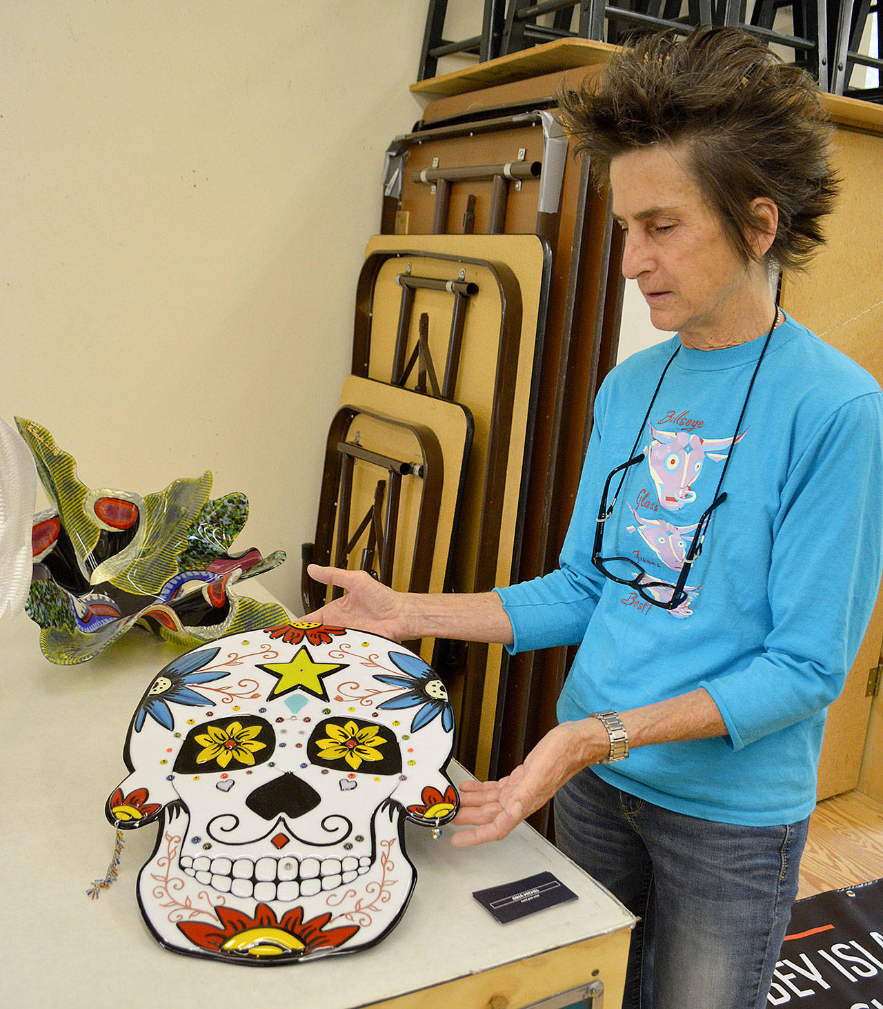 Gina Michel lifts her large fused glass sugar skull, one of her items that will be available at the Whidbey Island Glass Guild’s art show July 5 and 6 at Zech Hall. Photos by Laura Guido/Whidbey News Group