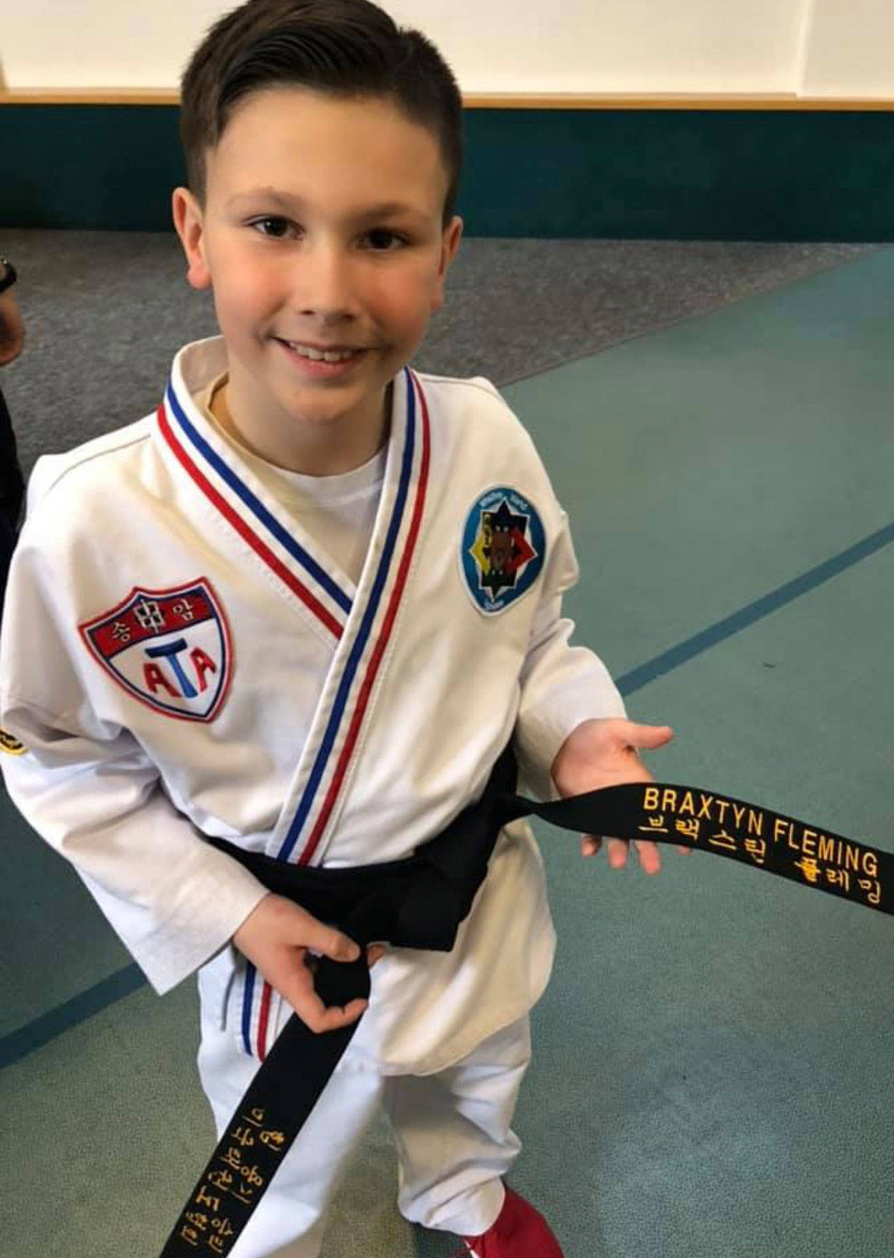 Braxtyn Fleming shows off the black belt he earned in February. (Provided photo)