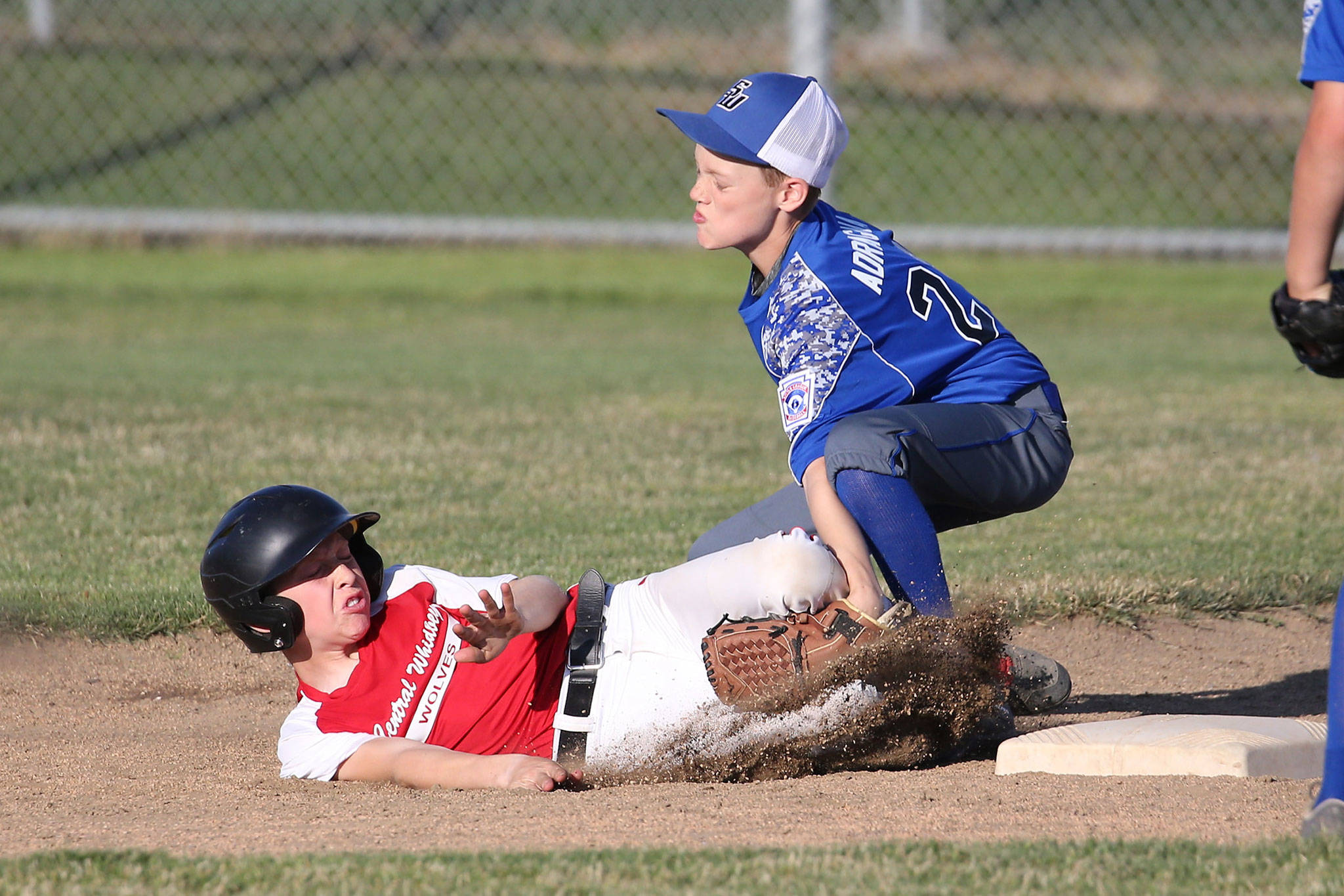 South Whidbey shortstop Jaden Adragna tags out Central Whidbey’s Chase Anderson trying to steal second base. (Photo by John Fisken)
