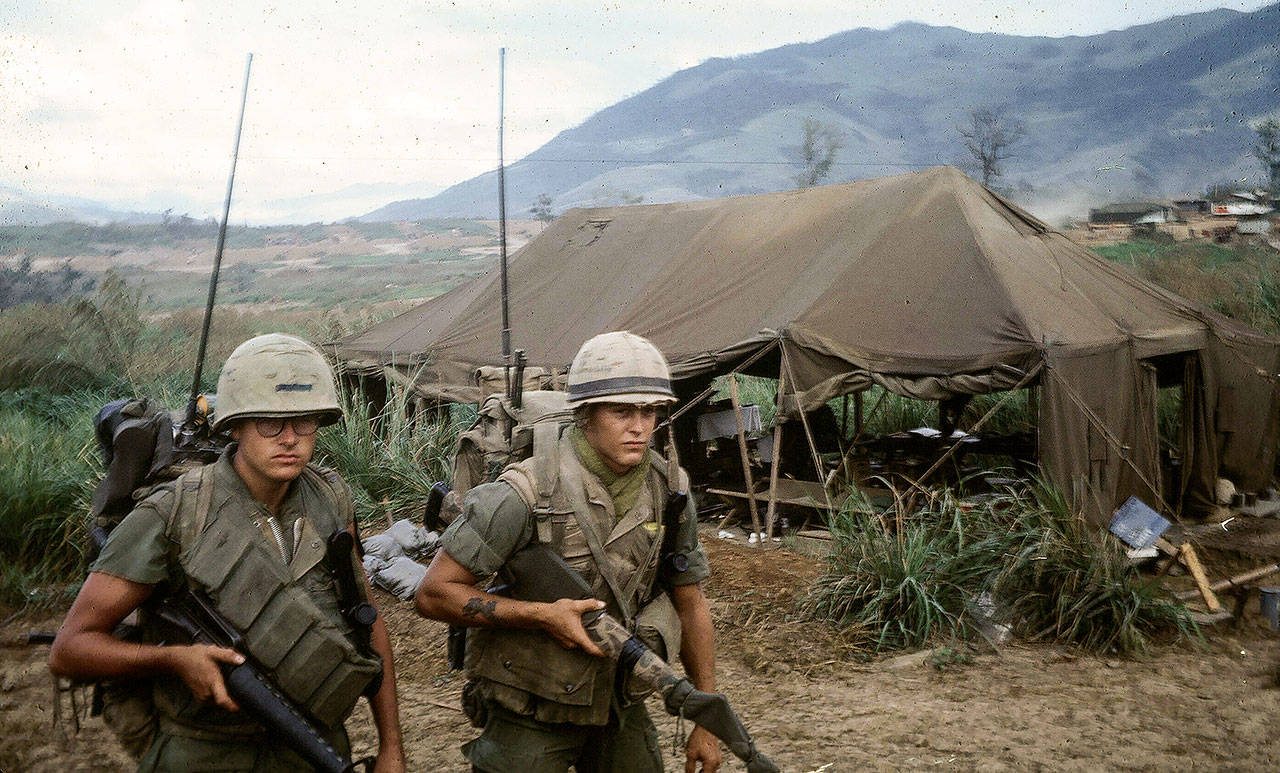 Jim Thompson (right) and fellow Marine radioman Bob Stout head to a landing zone at Vandegrift Combat Base in Quang Tri Province, Vietnam. (Family photo)