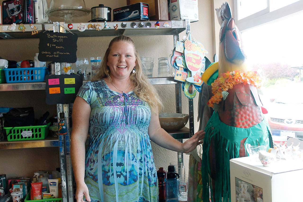 Tina Shorey with Rusty the Rooster, the store’s mascot. He gets dressed up for various holidays, and just for fun too. (Photos by Maria Matson/South Whidbey-Record)