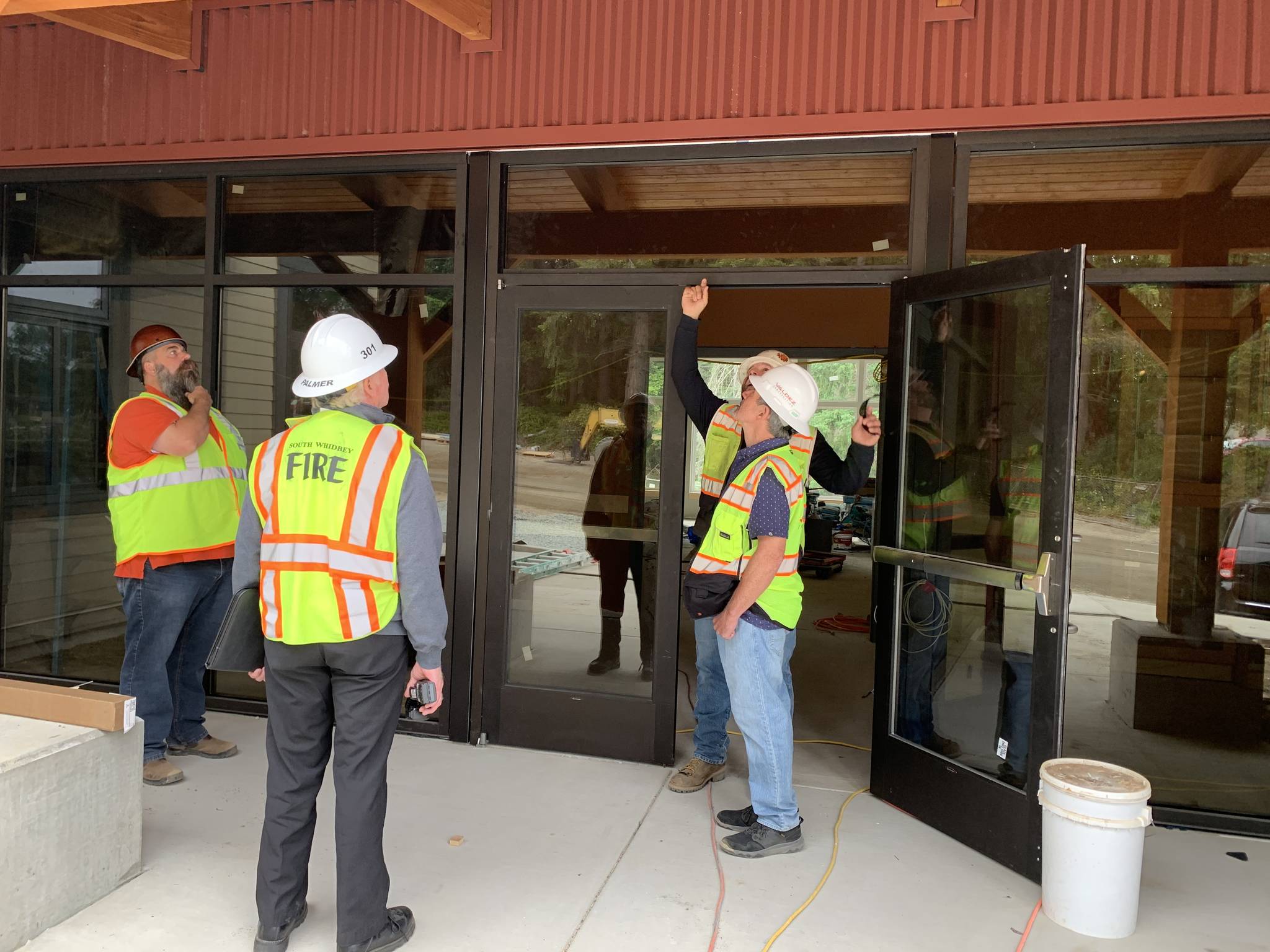 Workers and Chief Rusty Palmer put finishing touches on new firehouse on Bayview Road. Photo by Wendy Leigh/South Whidbey Record