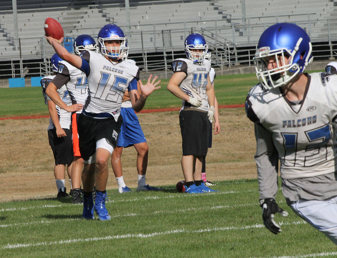 Quarterback Kole Nelson throws a pass during practice Thursday. The Falcon football team started Wedensday; the other South Whidbey sports begin Monday, Aug. 26. (Photo by Jim Waller/South Whidbey Record)