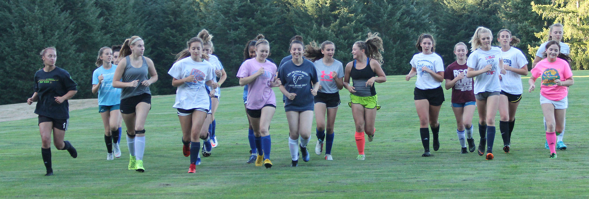The South Whidbey High School soccer team opens practice with several warmup laps Monday. (Photo by Jim Waller/South Whidbey Record)