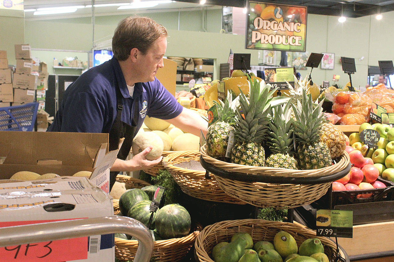 Employee Seth Haynie stocks organic produce at The Goose Community Grocer in Bayview. Photo by Wendy Leigh/South Whidbey Record