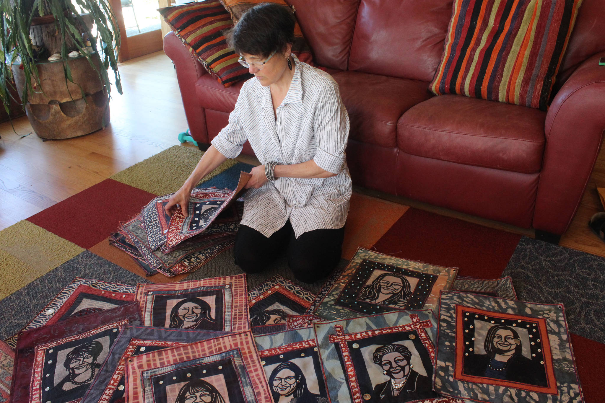 Fiber artist Cheryl Lawrence spreads out a selection of her 131 katazome textile art portraits of the women currently serving the 116th U.S. Congress