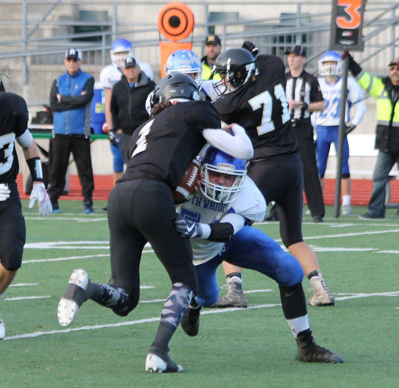 Wyatt De Mers makes a tackle in last year’s playoff game with Meridian. De Mers, a two-way, first-team all-league selection, returns this year to lead the Falcons. (Photo by Jim Waller/South Whidbey Record)