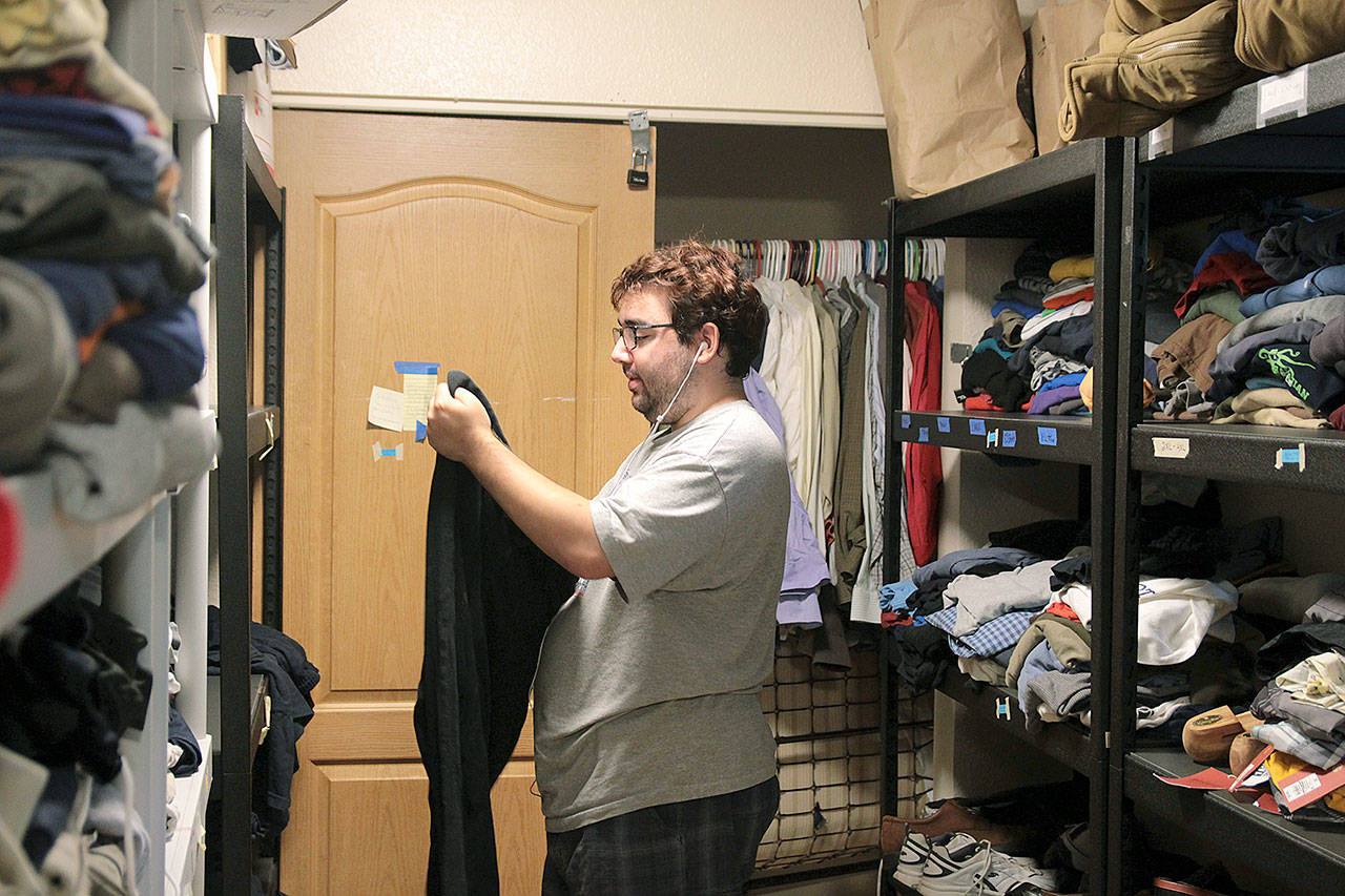 Photo by Laura Guido/Whidbey News-Times                                Nathan Crisafulli, 24, helps put away donated clothing that’s available to young people staying at Ryan’s House for Youth or those who visit the drop-in center.