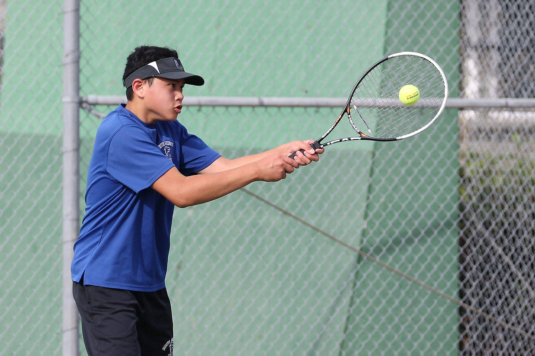 South Whidbey’s Jordan Wu slaps a handhand in his third doubles win at Coupeville Wednesday. (Photo by John Fisken)