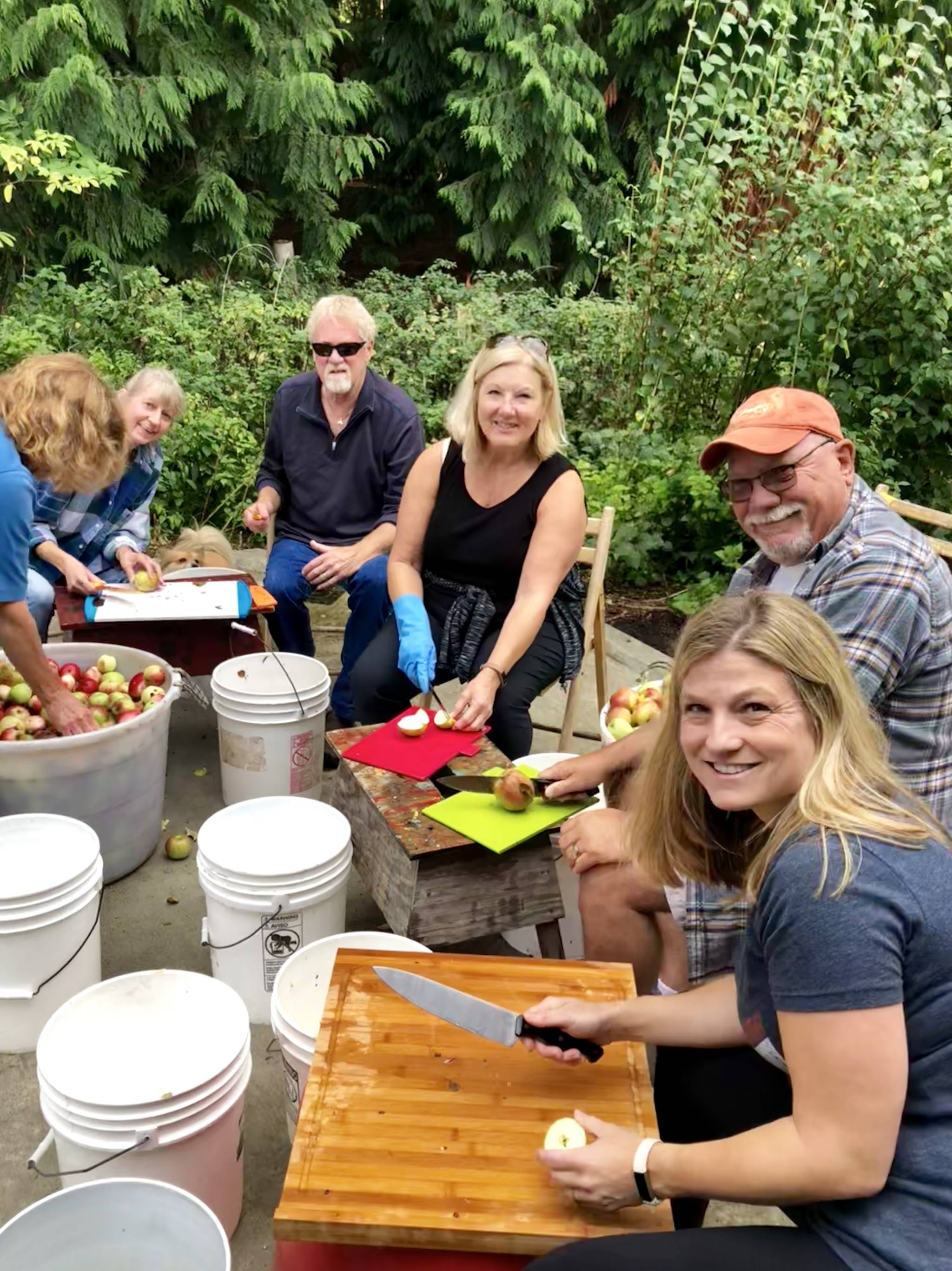 Community and family gather for annual cider pressings. Pitching in are Karen Krug, founder and co-owner of Spoiled Dog Winery; Steve and Sherry Ostrander, Bob and Carol Bright and Lindsay Krug. Photo courtesy of Lindsay Krug.