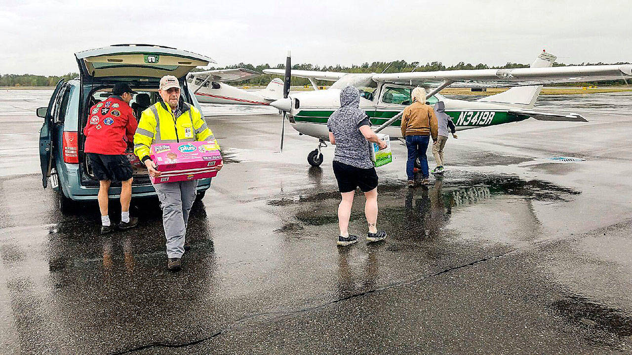 Clallam County Disaster Airlift Response Team load supplies into an airplane during an exercise at Bellingham International Airport last year. This is the first year that Community Emergency Response Team members from Whidbey are participating in the regional drill. (Photo by Tara Terry, provided by NW Regional Emergency Services)
