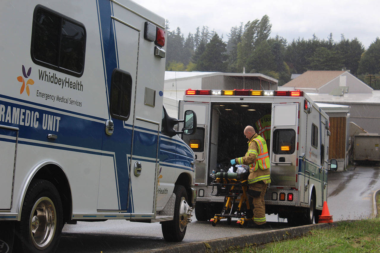 Emergency responders load injured patients into WhidbeyHealth ambulances and paramedic units after the Sept. 17 collision along Highway 525. (Photo by Wendy Leigh/South Whidbey Record)