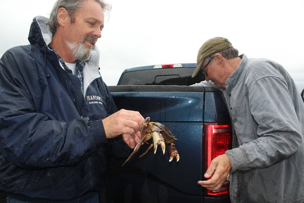 Craig Brooks, left, and Mike Halstead show off their crab catch at Langley marina after the Oct. 1 re-opening of Whidbey waters for recreational crabbing. Photo by Wendy Leigh / South Whidbey Record