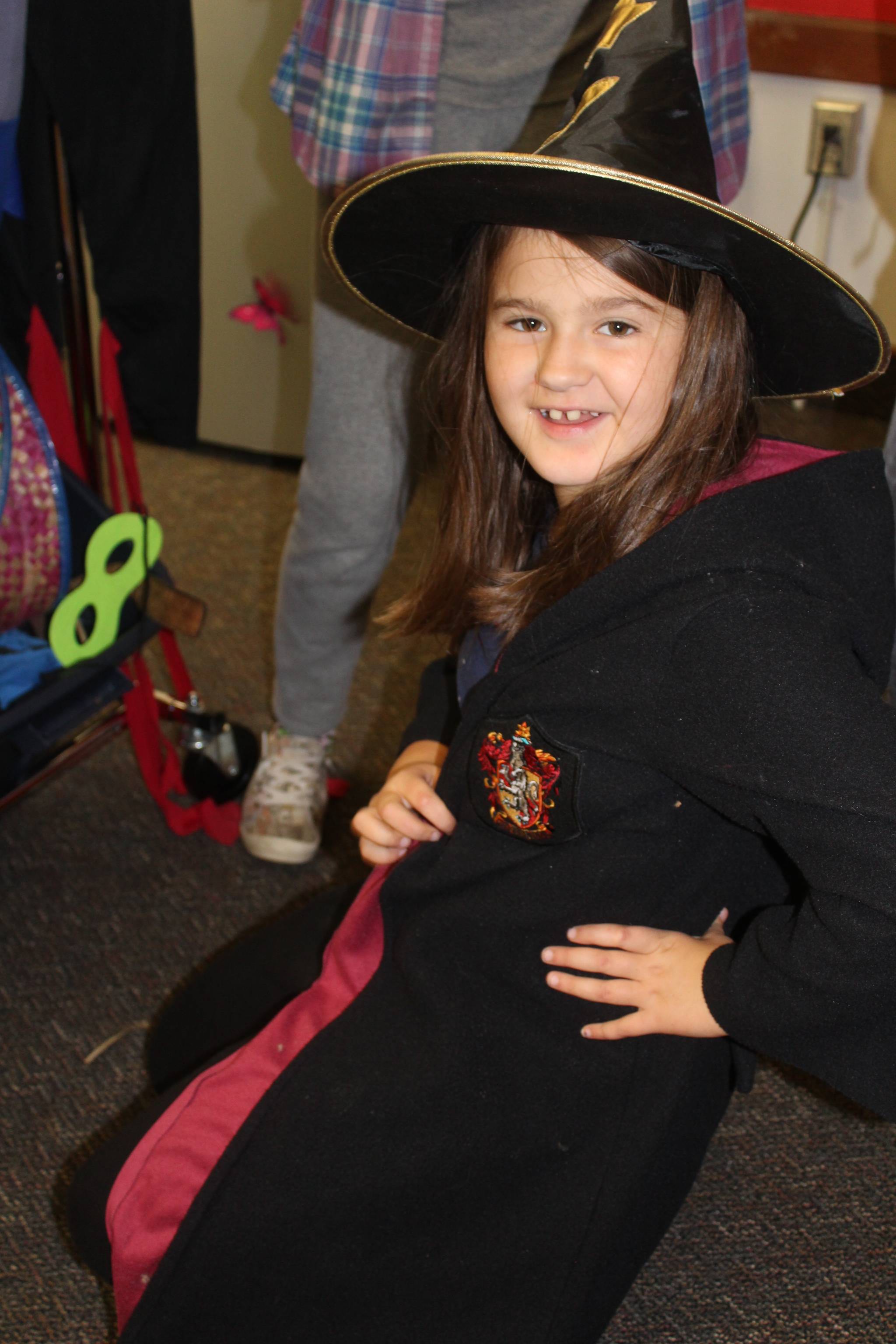 June Murray tries on a witch costume at the Family Resource Center in Langley, home to the free Halloween Costume Swap by Readiness to Learn. Photo by Wendy Leigh / South Whidbey Record
