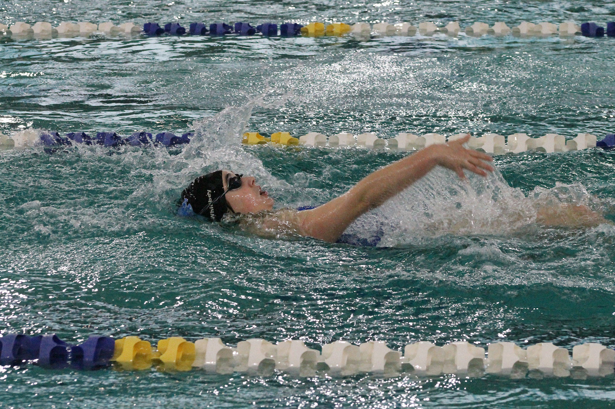 Katie Zundel glides to sixth place in the 100 backstroke.(Photo by Jim Waller/South Whidbey Record)