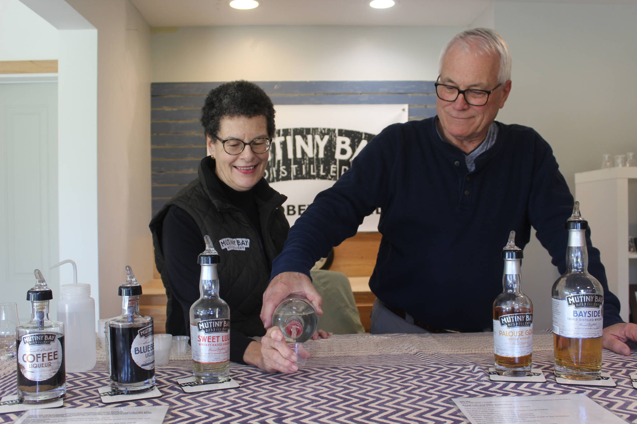 Rod and Kathy Stallman, owners of Mutiny Bay Distillers, pour hand-crafted small-batch whiskeys at the tasting bar. Photo by Wendy Leigh / South Whidbey Record