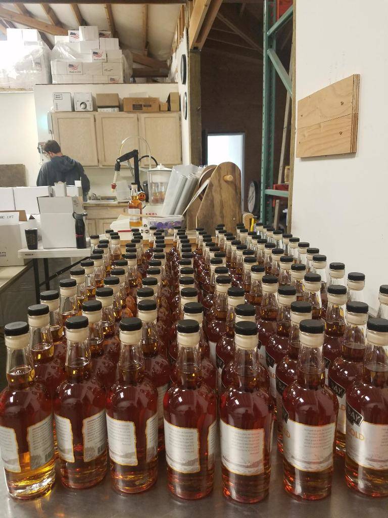 Craft whiskeys at Mutiny Bay Distillery are bottled and labeled by hand. Photo courtesy of Mutiny Bay.