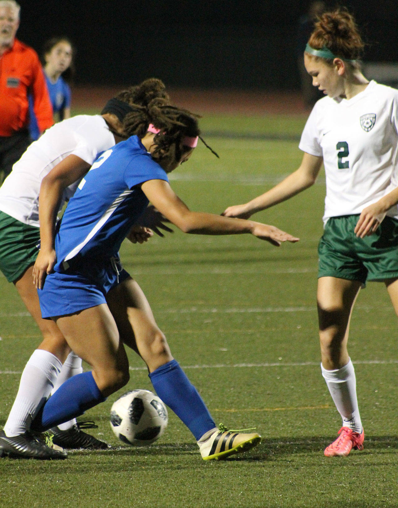 Simone White, center, battles for possession for South Whidbey.(Photo by Jim Waller/South Whidbey Record)