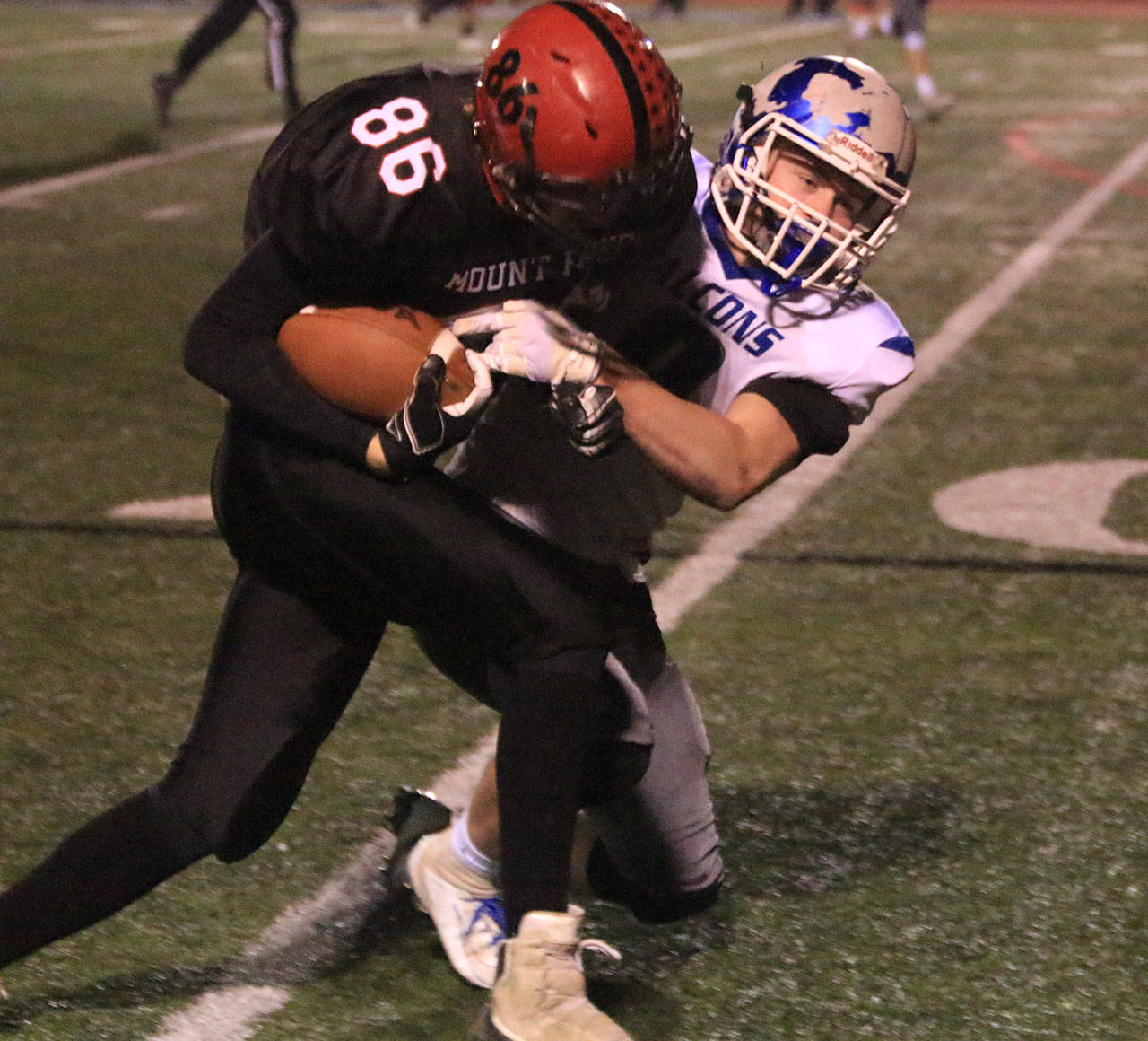 Bodie Hezel brings down Mount Baker’s Waylon Kentner.(Photo by Jim Waller/South Whidbey Record)