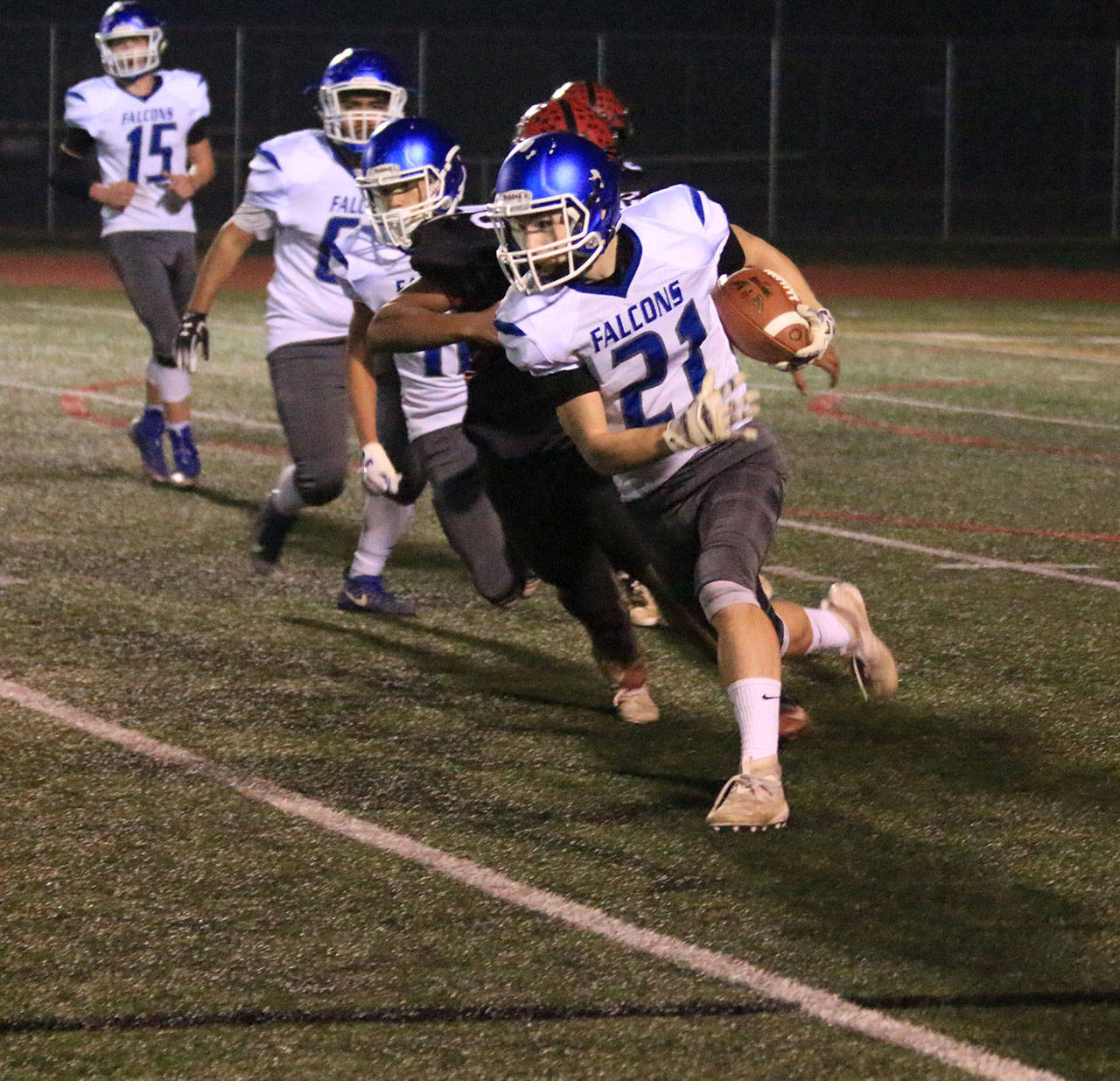 Billy Rankins scoots around end for the Falcons.(Photo by Jim Waller/South Whidbey Record)