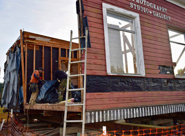Earlier this month, workers disassembled the remaining half of Whidbey Telecom’s “Little Red Building” that had sat empty in Langley for a dozen years. Photo by Patricia Guthrie