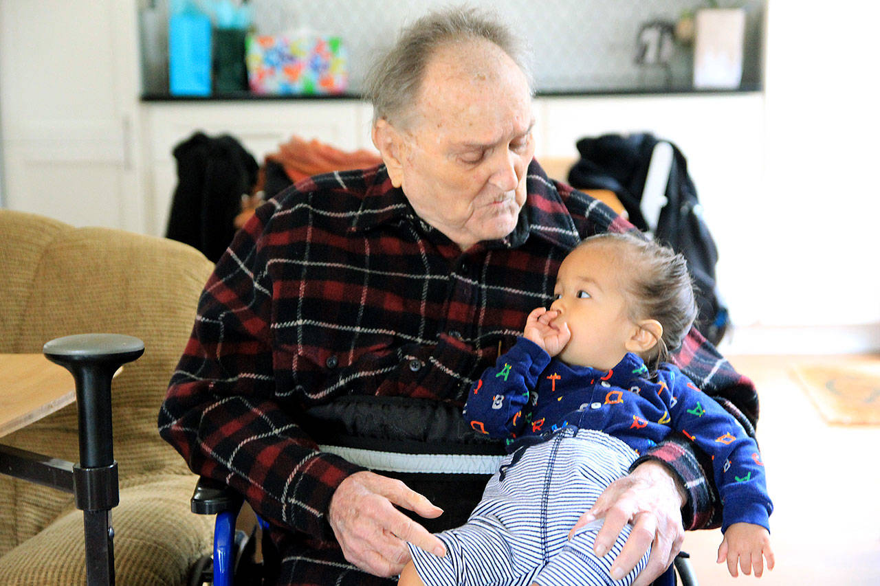 Photo by Kira Erickson.                                John Bozin, 100, with great-grandson Rahi Sanyal, 1.