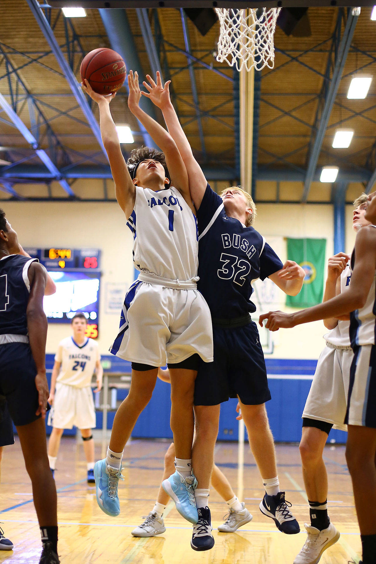 Jacob Ng (1) powers to the hoop for the Falcons.(Photo by John Fisken)