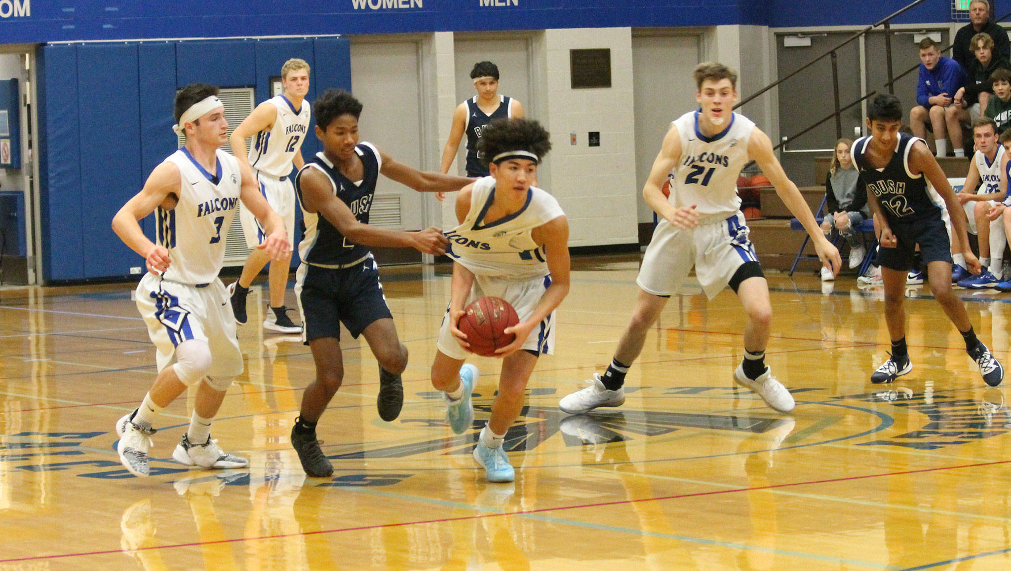 A Bush defender figured out the best way to slow down the South Whidbey attack, grabbing the jersey of Jacob Ng.(Photo by Jim Waller/Sound Whidbey Record)