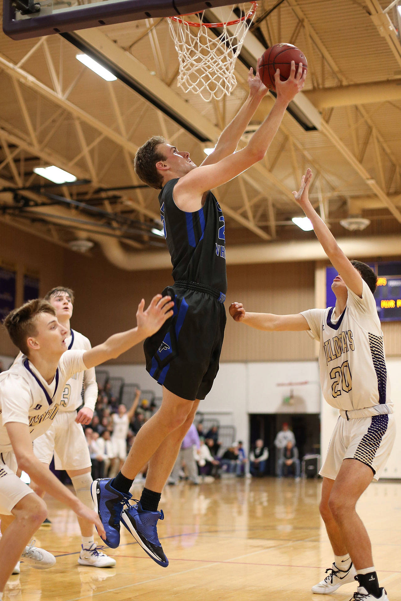 Levi Buck soars above three Wildcats to score for South Whidbey.(Photo by John Fisken)