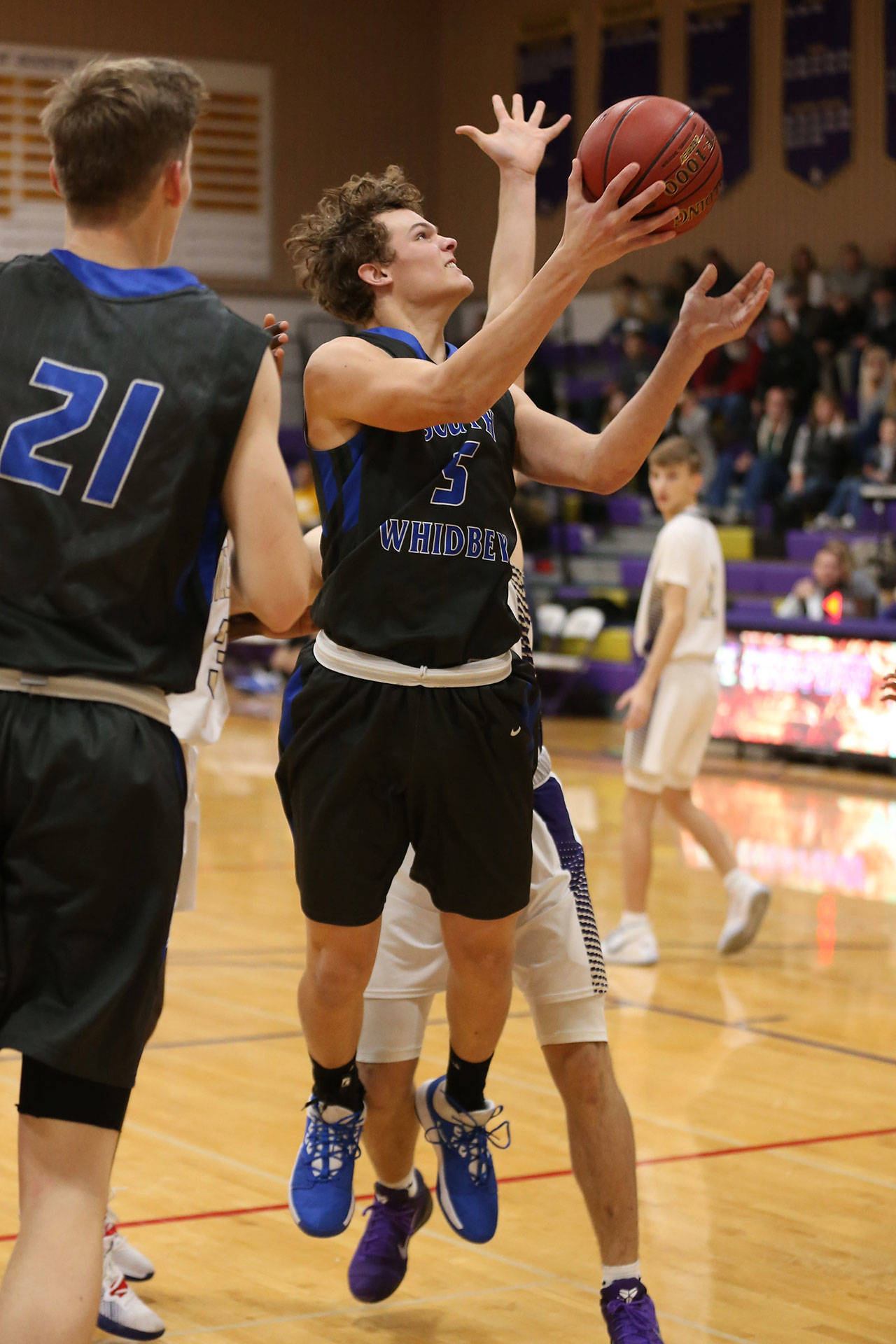 Cody Eager is fouled on the way to the basket.(Photo by John Fisken)