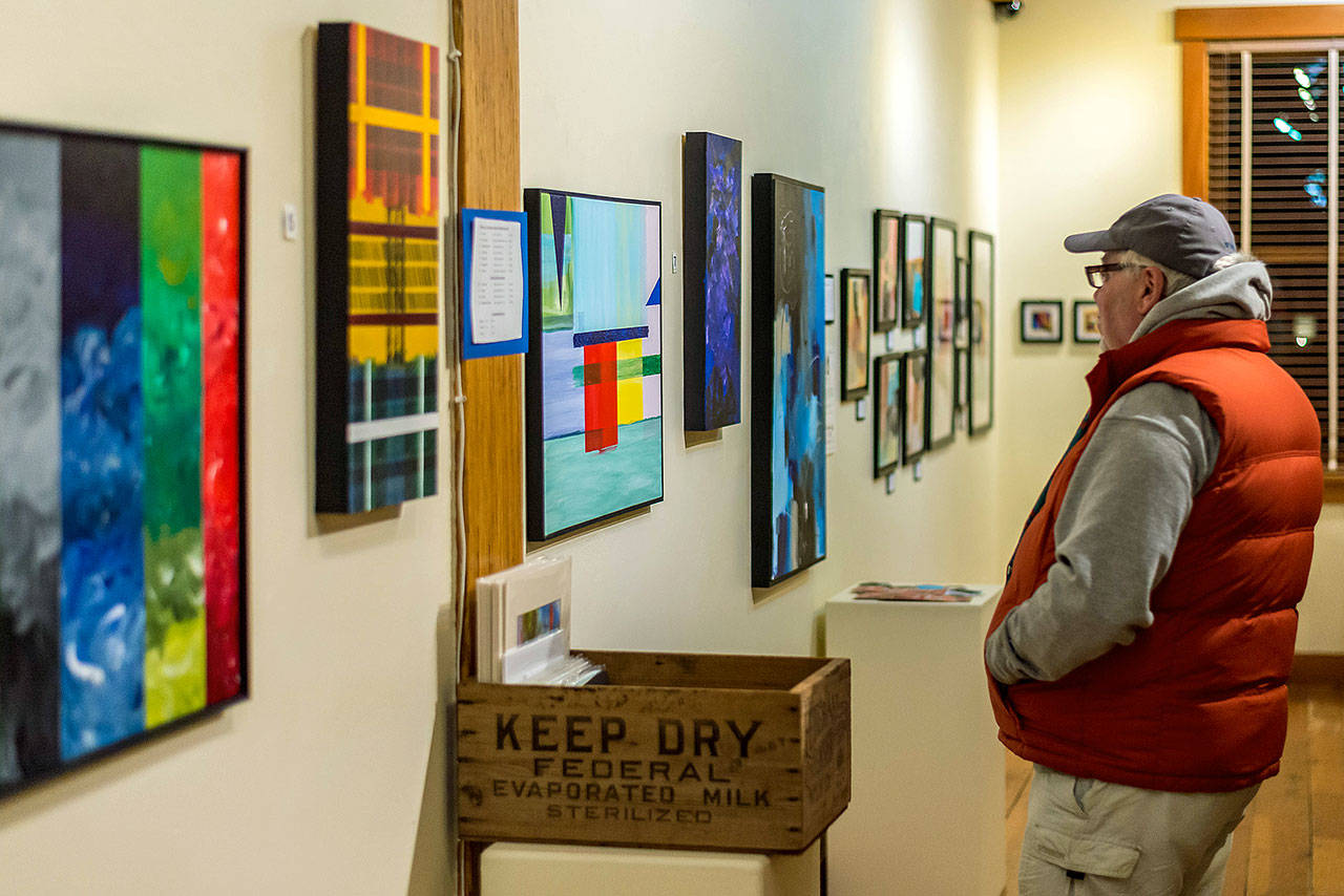 Photo courtesy of Rich Yukubousky                                A visitor admiring Abstract x4 on the night of the Dec. 6 gallery opening.