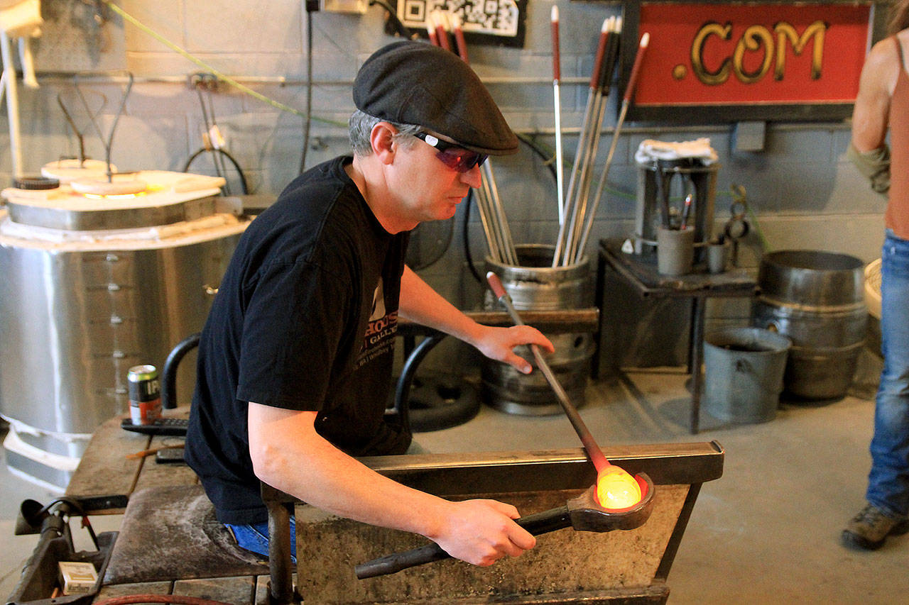 Photo by Kira Erickson / Whidbey News Group                                Glass artist Callahan McVay shows how to shape a sea float during a demonstration.