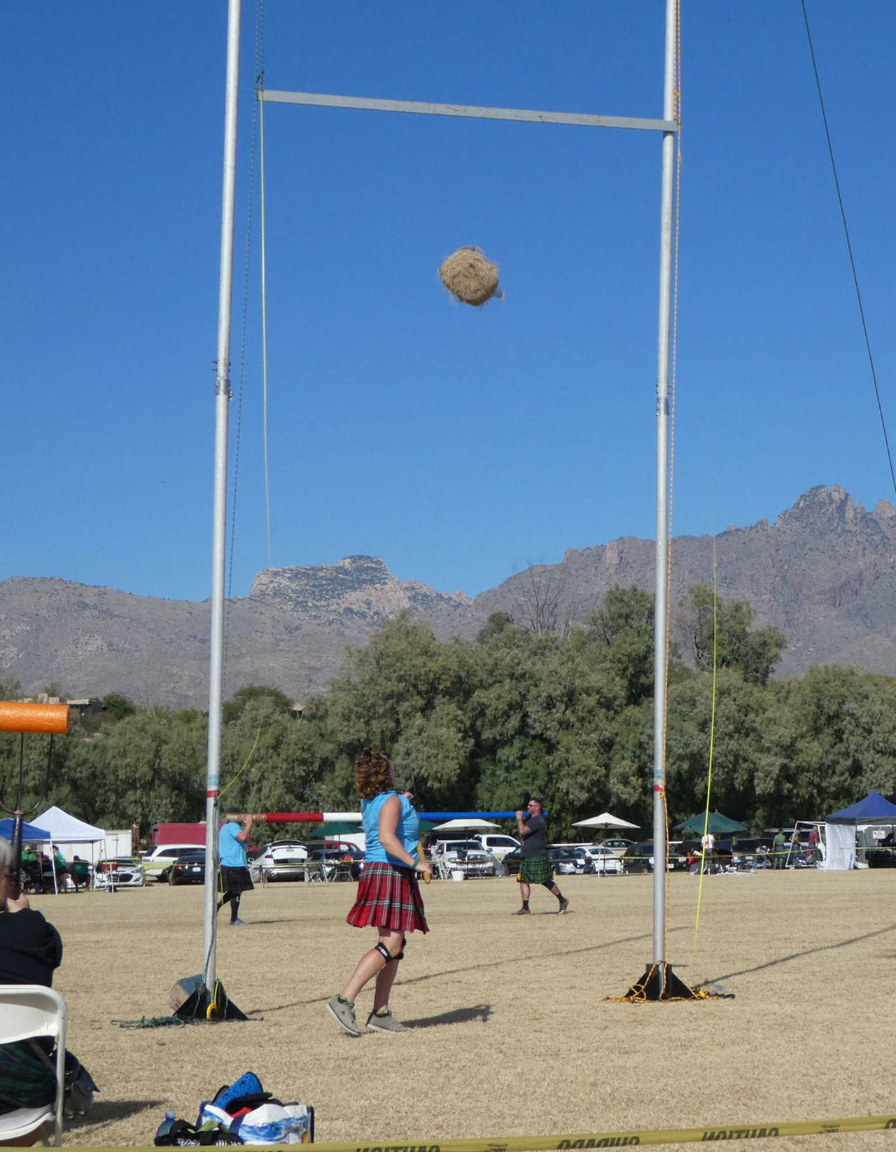 Tishia Malone tries to throw a bag of rope over a bar in the Highland games. (Provided photo)