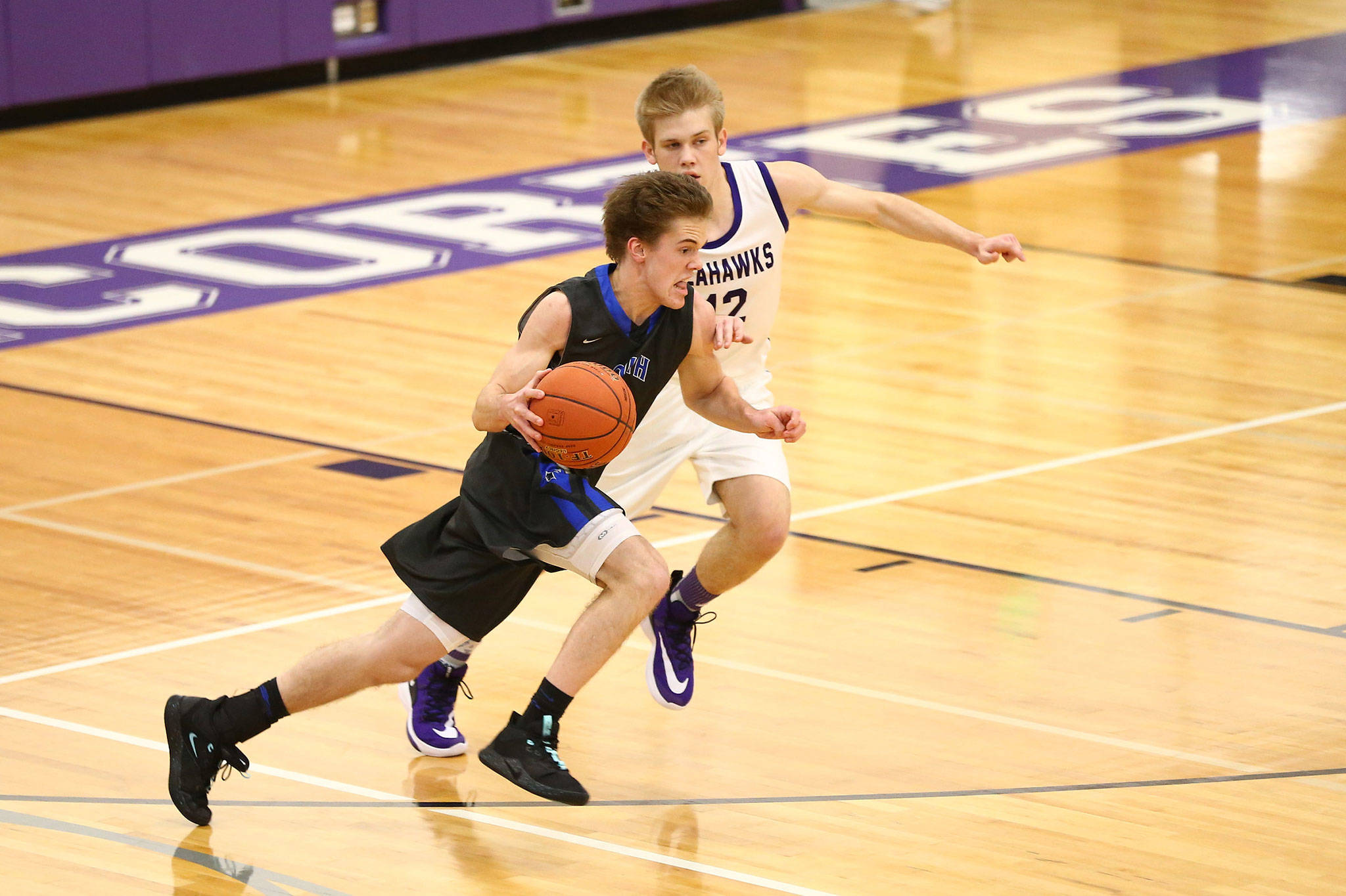 South Whidbey’s Nick Young dribbles through Anacortes’ defense. (Photo by John Fisken)
