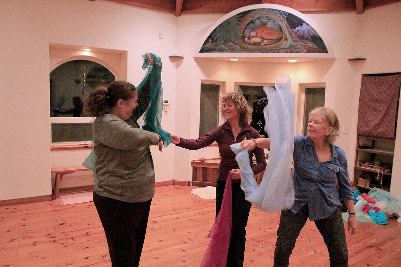 Photos by Kira Erickson / Whidbey News Group                                Deb Helfrich, left, dances with neighbors Kimmer Morris and Jane Klassen, who helped heal her.