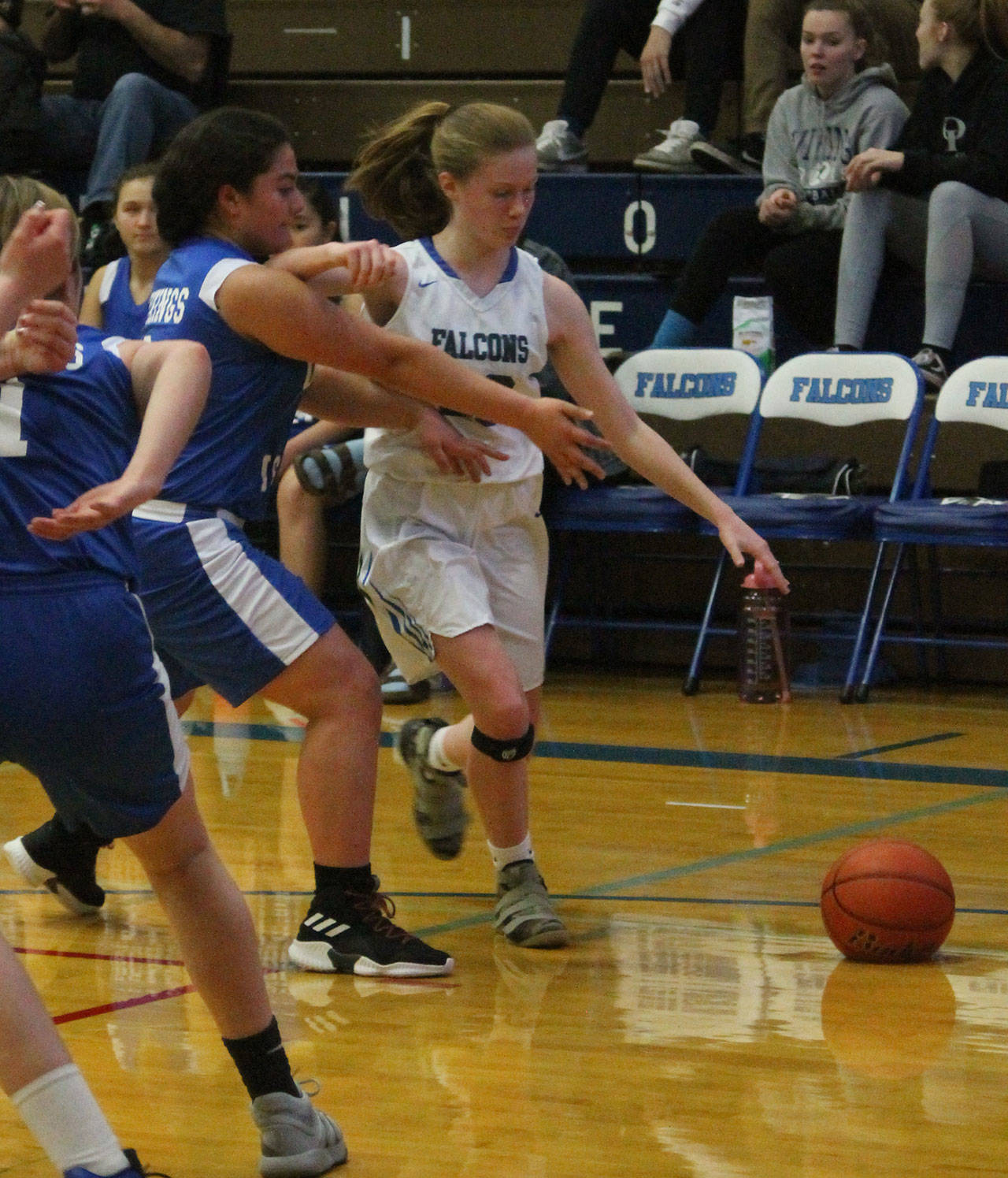 Liz Haines clears some space as she attacks the baseline.(Photo by Jim Waller/South Whidbey Record)