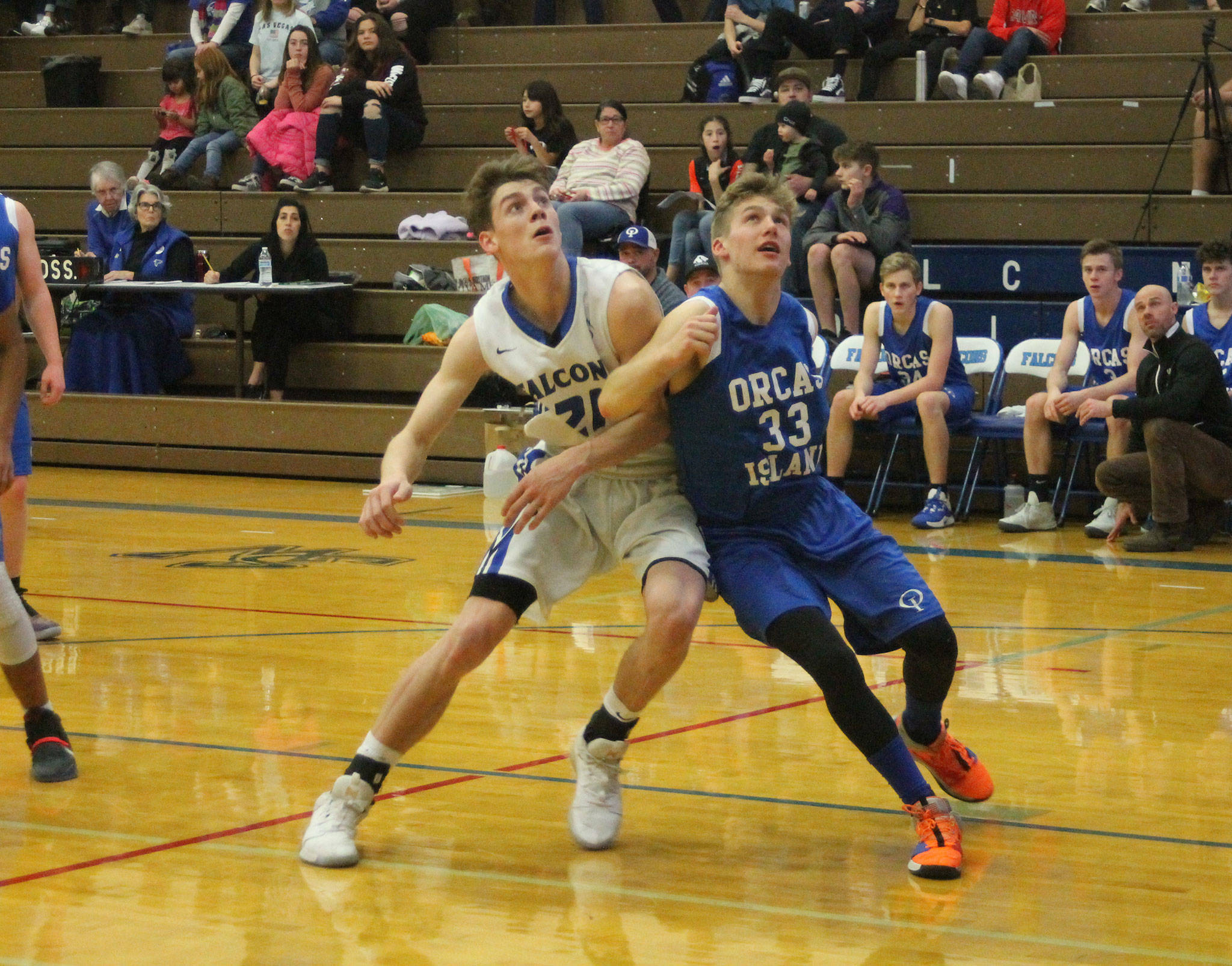 South Whidbey’s Carson Wrightson fights Orcas Island’s August Groeninger (33) for rebounding position.(Photo by Jim Waller/South Whidbey Record)
