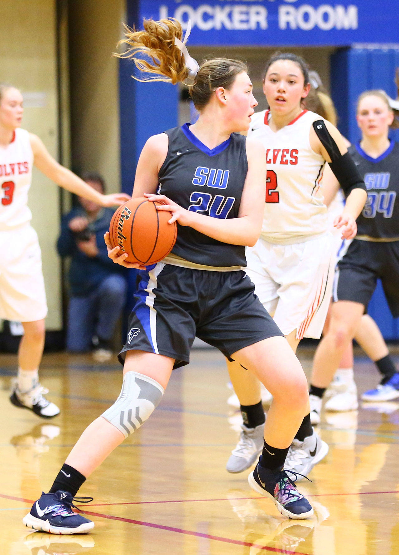 Ella Wood protects the ball for South Whidbey.(Photo by John Fisken)