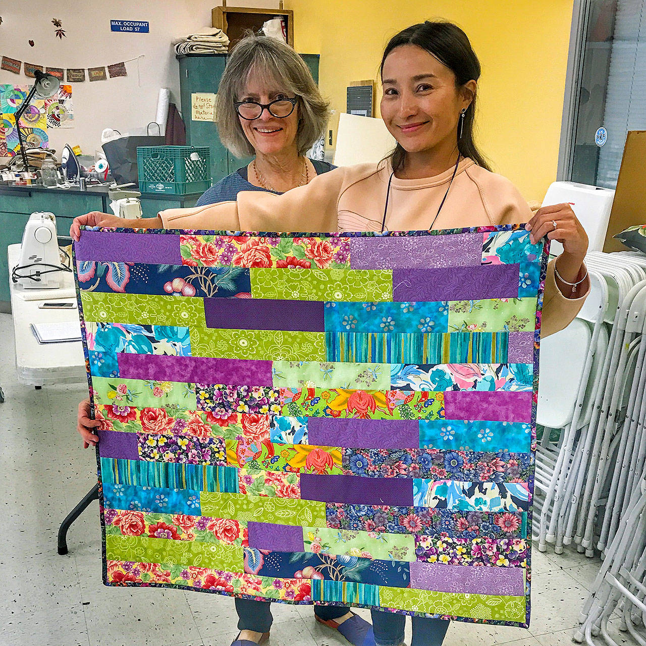 Photo courtesy of Luanne Seymour                                 Darcy Sinclair, left, and Zhanar Tulegenova display a blanket they made together.