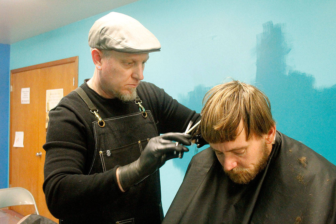 Hairdresser William Bolding cuts Jesse Hall’s hair on Jan. 23 at the South End’s Point in Time Count.