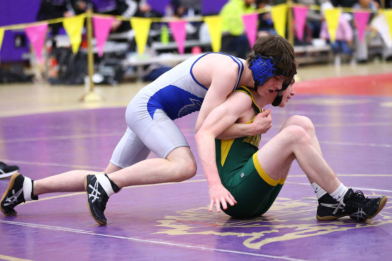 Hugh Foster, left, works to bring his opponent to the mat.(Photo by John Fisken)