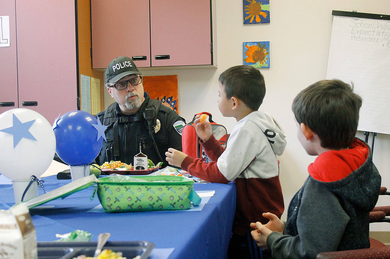 Photo by Kira Erickson/Whidbey News Group                                Chief of Police Don Lauer answers questions from first grader Ryu Peng and second grader Logan Caravan on Thursday.