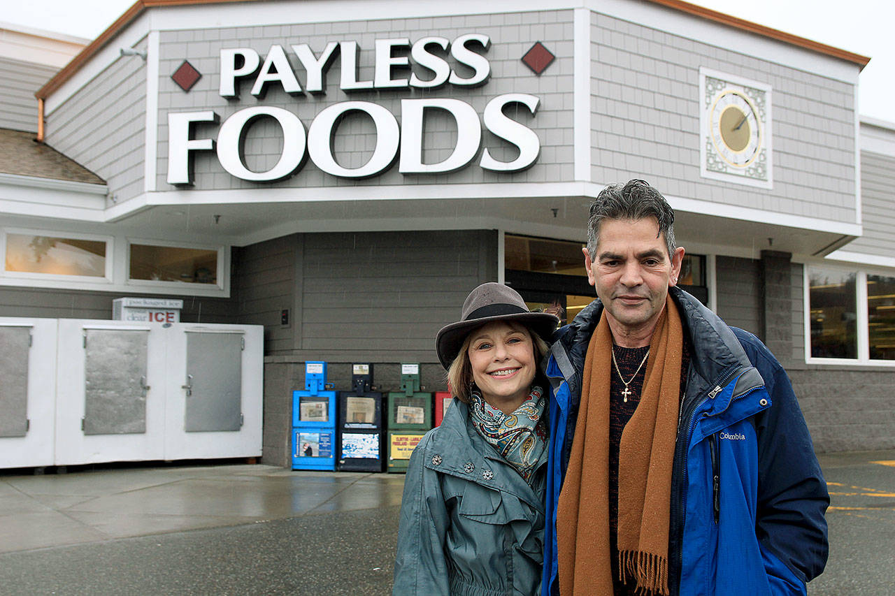 Photo by Kira Erickson/Whidbey News Group                                 Betsy and Amir Shirazi stand in front of Payless Foods in Freeland, where the winning ticket was purchased last month.