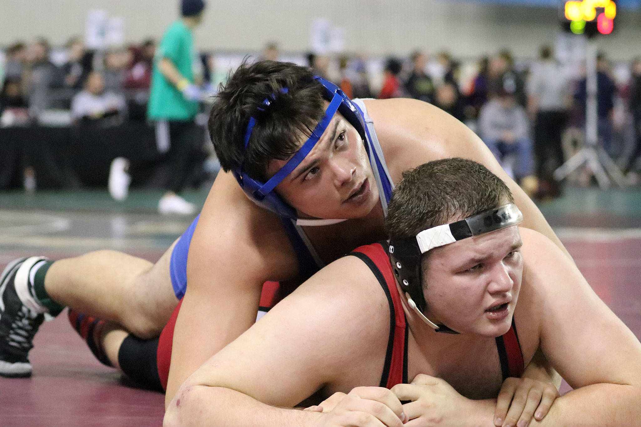 South Whidbey’s Dylan Davis, top, wrestles in the state tournament last weekend. Davis finished fourth in the 285-pound class. (Photo by Sarah Manchester)