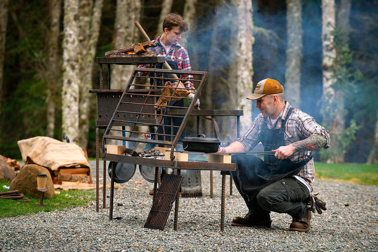 Photo provided                                Chef JP Dowdell, right, and firemaster Baron Molo cook food on a fire table of Dowdells creation.