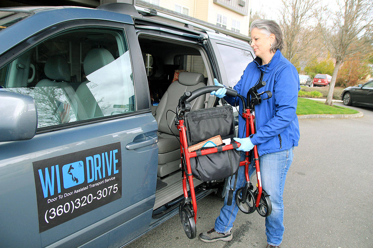 Photo by Kira Erickson/Whidbey News Group                                WI DRIVE Founder Heather Mayhugh loads a walker into her van for a client.