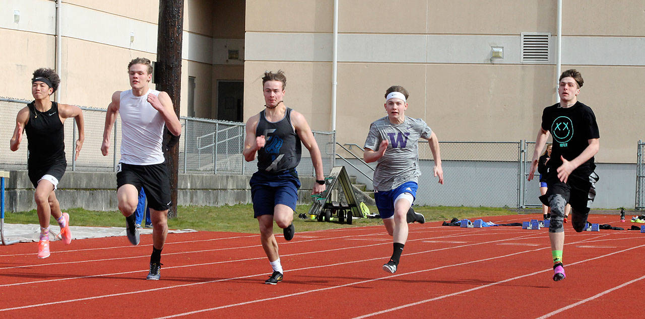 Jacob Ng, left, Cody Eager, Bodie Hezel, Billy Rankin and Kole Nelson compete in the 100 meters. (Photo by Jim Waller/South Whidbey Record)